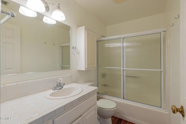 bathroom with combined bath / shower with glass door, visible vents, toilet, and vanity