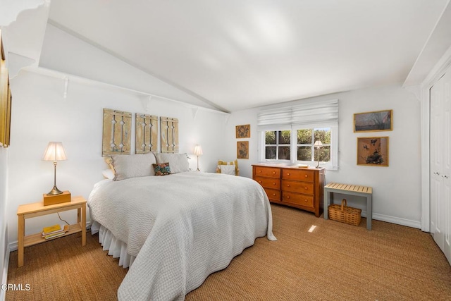 bedroom featuring a closet, baseboards, carpet, and vaulted ceiling