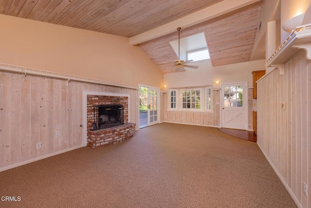 unfurnished living room featuring wood ceiling, carpet floors, beam ceiling, and a fireplace