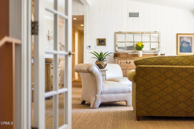 living area with visible vents and carpet floors