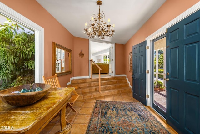 entrance foyer featuring light tile patterned floors, baseboards, and a chandelier