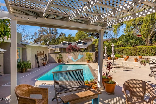 view of swimming pool with a patio, a fenced in pool, fence, and a pergola