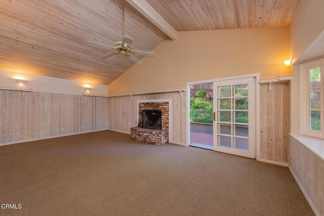 unfurnished living room with carpet, high vaulted ceiling, a fireplace, wooden ceiling, and beamed ceiling