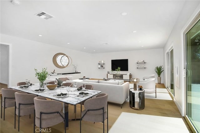 dining space featuring light wood-style floors, visible vents, and recessed lighting