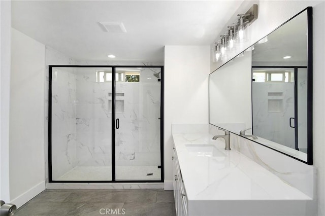 full bathroom featuring a wealth of natural light, vanity, and a marble finish shower