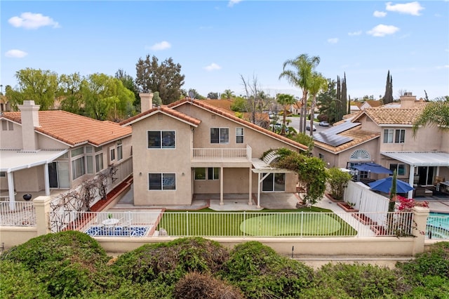 40115 Starling St, Temecula, CA 92591 - back of house with a fenced backyard, stucco siding, a chimney, a residential view, and a tiled roof