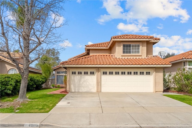 mediterranean / spanish home featuring an attached garage, driveway, a front yard, and stucco siding