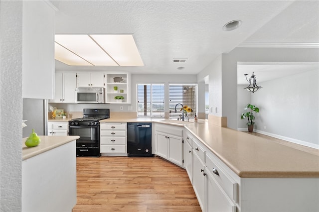 40115 Starling St, Temecula, CA 92591 - kitchen with black appliances, open shelves, light wood finished floors, white cabinetry, and light countertops