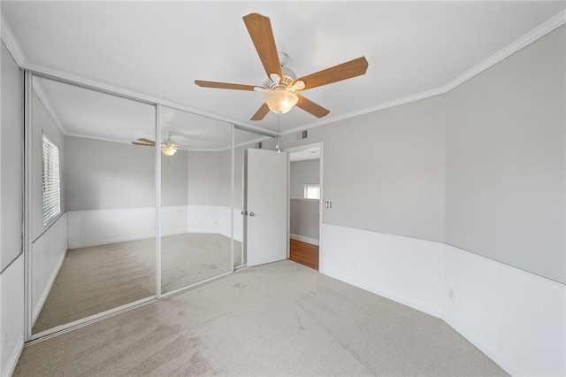 40115 Starling St, Temecula, CA 92591 - unfurnished bedroom with carpet floors, ornamental molding, a ceiling fan, a closet, and wainscoting
