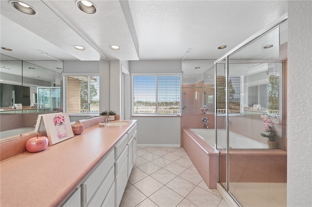 40115 Starling St, Temecula, CA 92591 - full bath featuring a textured ceiling, a garden tub, vanity, tile patterned floors, and a shower stall
