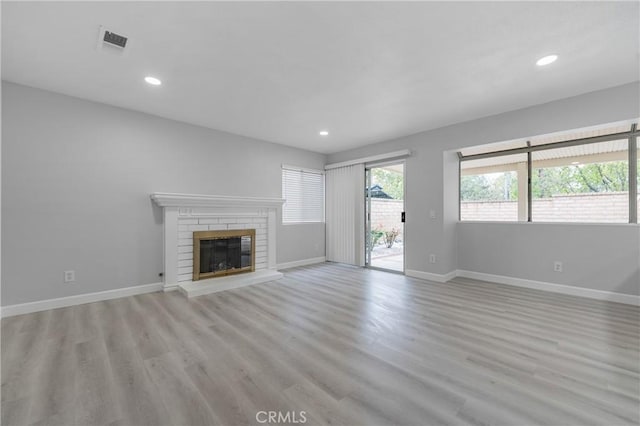 unfurnished living room with recessed lighting, visible vents, light wood-style flooring, and baseboards