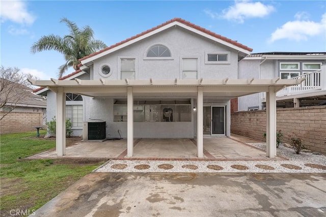 back of property with a patio, fence, central AC, and stucco siding