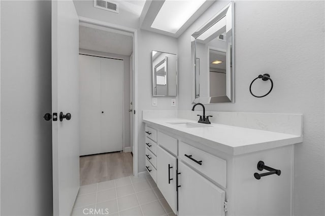 bathroom featuring tile patterned flooring, visible vents, and vanity