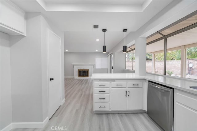 kitchen with white cabinetry, visible vents, light countertops, and dishwasher