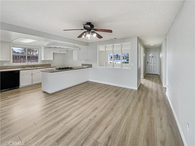 kitchen with dishwasher, light wood-type flooring, baseboards, and white cabinets