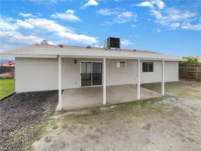 back of house with a patio, cooling unit, fence, and stucco siding