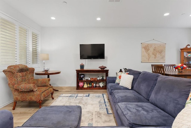 living area with visible vents, wood finished floors, and recessed lighting