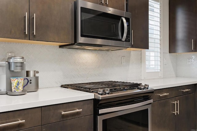 kitchen with appliances with stainless steel finishes, light countertops, dark brown cabinetry, and tasteful backsplash