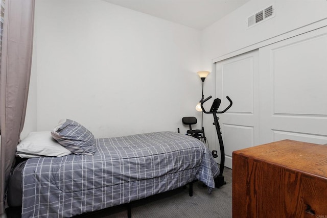 carpeted bedroom with a closet and visible vents