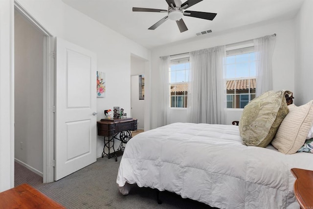 bedroom with carpet floors, visible vents, and a ceiling fan