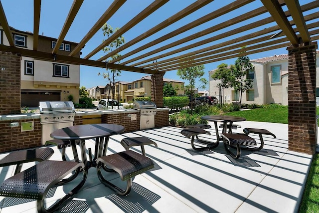 view of patio with grilling area, an outdoor kitchen, and a pergola