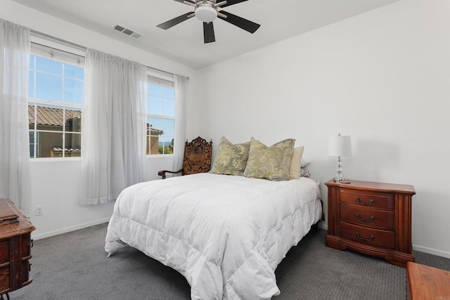 bedroom featuring carpet floors, baseboards, visible vents, and a ceiling fan