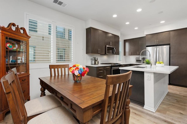 dining room with light wood-style flooring, visible vents, and recessed lighting