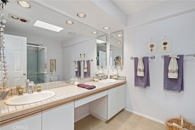 full bath with double vanity, a stall shower, a sink, and recessed lighting