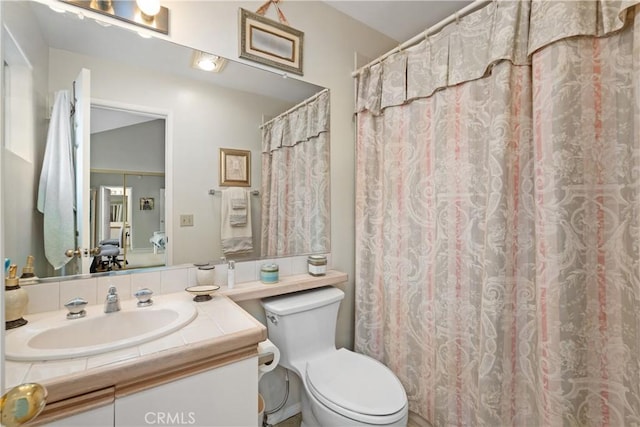 bathroom with toilet and vanity