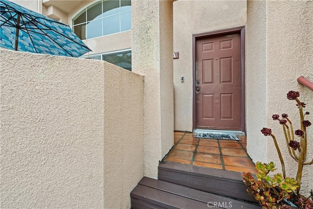 doorway to property with stucco siding