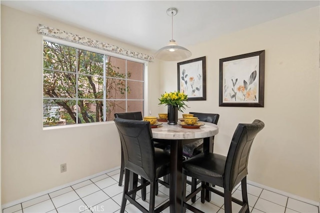 dining room featuring light tile patterned flooring and baseboards