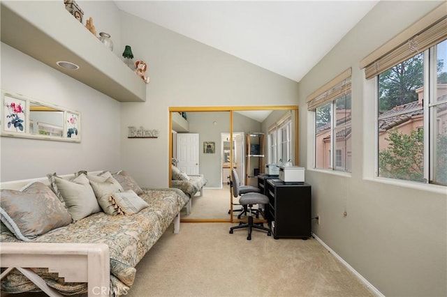 home office featuring vaulted ceiling, baseboards, and light colored carpet