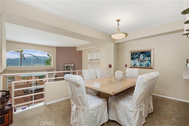 dining area featuring carpet flooring and baseboards