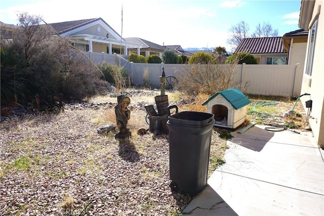 view of yard with fence and a patio