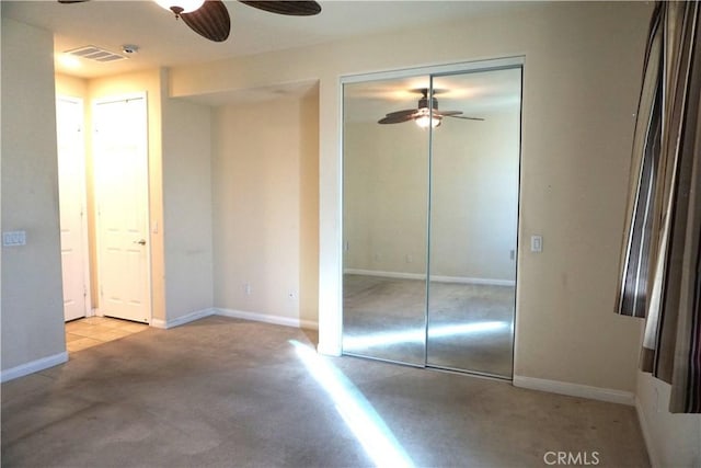 unfurnished bedroom with ceiling fan, carpet floors, visible vents, and baseboards