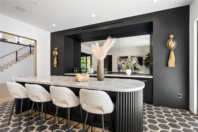 bar featuring a dry bar, stairway, and recessed lighting