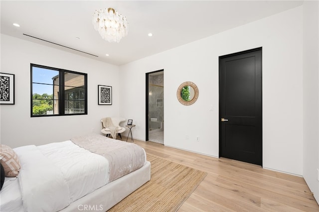 bedroom with connected bathroom, recessed lighting, a notable chandelier, and light wood-style flooring