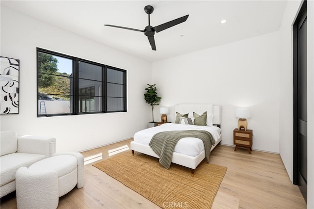 bedroom featuring light wood finished floors, a ceiling fan, and recessed lighting