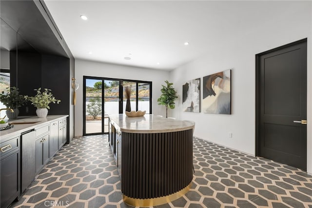 interior space with carpet flooring, a sink, and recessed lighting