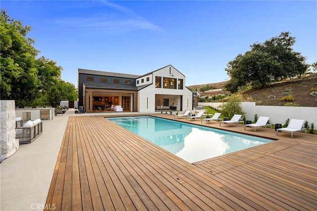 view of pool with a fenced in pool, a patio area, fence, an outdoor structure, and a storage structure