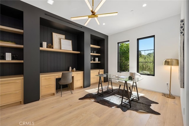 home office with built in features, recessed lighting, light wood-style flooring, and built in desk