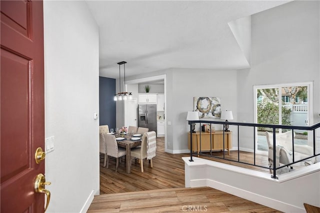 foyer with light wood finished floors and baseboards