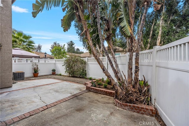 view of patio with a fenced backyard and central air condition unit