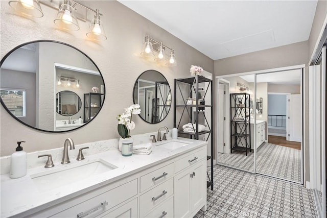 full bathroom featuring a sink and double vanity