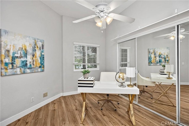 office area featuring a ceiling fan, baseboards, and wood finished floors