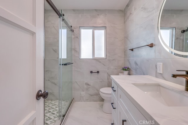 full bathroom featuring toilet, a stall shower, tile walls, and vanity