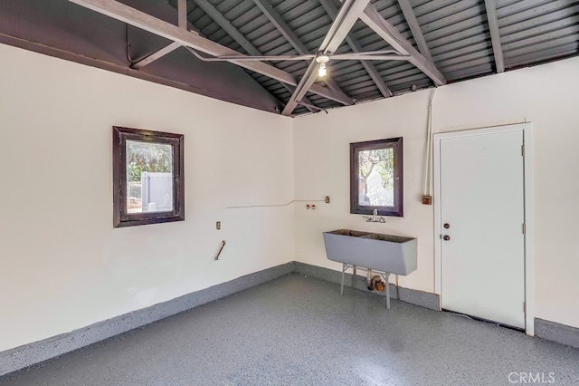 garage with a sink and baseboards