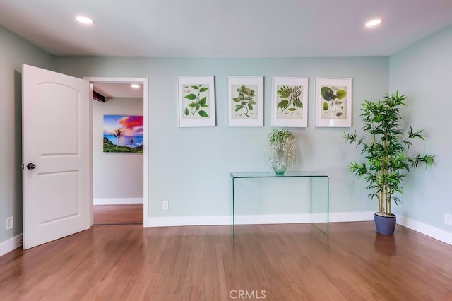 interior space featuring recessed lighting, baseboards, and wood finished floors