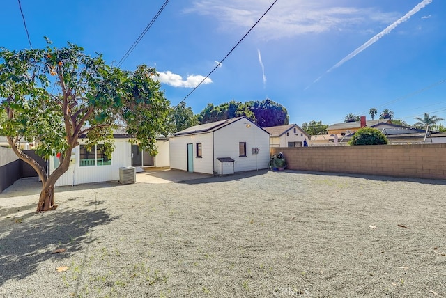 back of property featuring a patio, central AC unit, and a fenced backyard