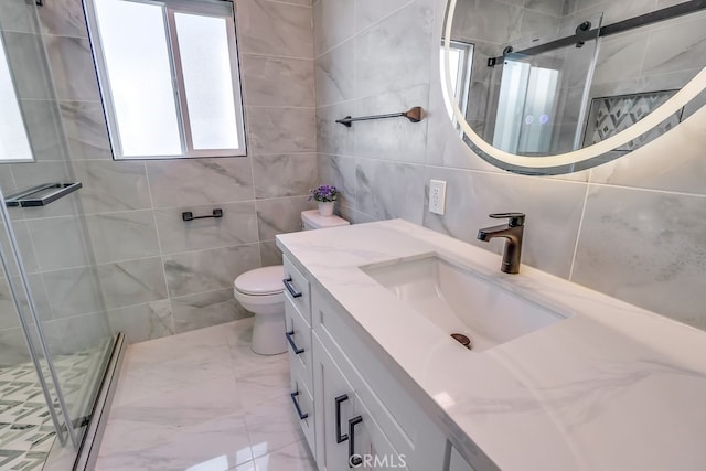 full bath featuring a stall shower, marble finish floor, tile walls, and vanity